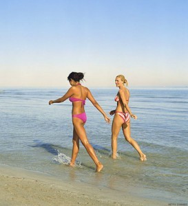 Two women enjoying Donegal's recent heatwave with a paddle along the beach shoreline.