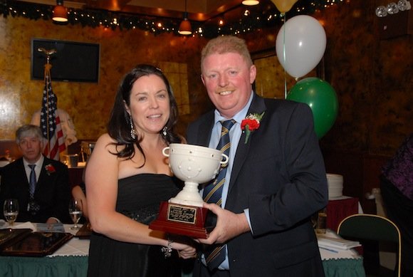 Donegal NY Chairman Laurence McGrath presents Michelle Comar with a special award for her hard work in support of the Club and the annual banquet.