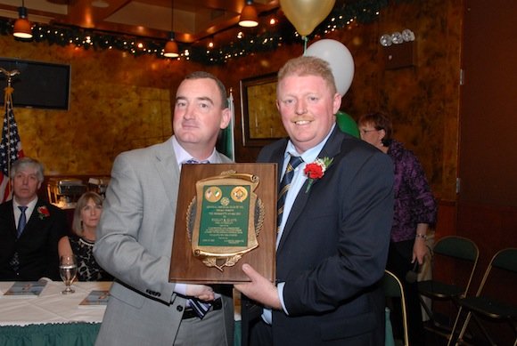 Keelan McLaughlin receives the "Club Person of the Year" award from Donegal GFC NY Chairman Laurence McGrath at the 2012 Club banquet.