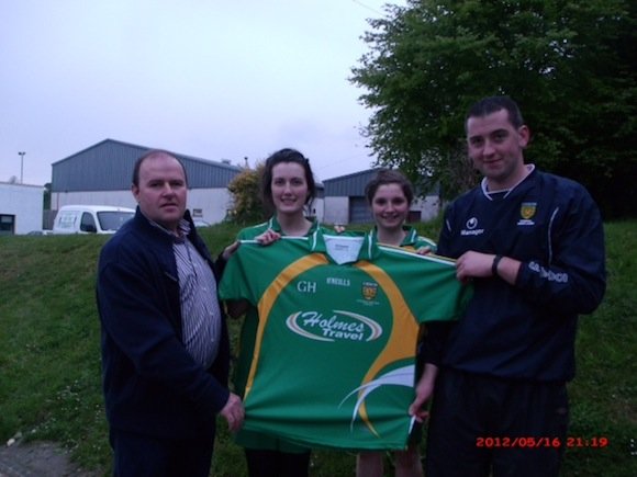 Gerard Holmes of Holmes Buses presenting Hugh Donnelly (Manager), Emer Gallagher and Claire Brady (players) with training jerseys.