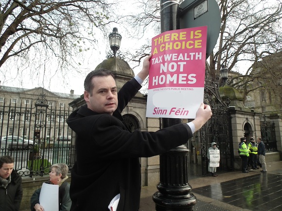 Pearse Putting up Poster at Dáil Eireann