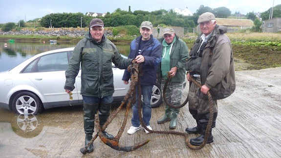 The friends pose after salvaging the anchor from The Mall in Ballyshannon.