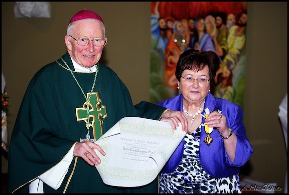 Mary receives her papal award from Bishop Boyce.