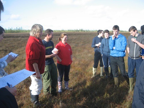 Ecologists Billy Flynn and Éanna Ní Lamhna, geography teacher Mary Martin and transition-year students from St. Columba's Comprehensive School in Glenties discuss the wildlife found in a local bog.