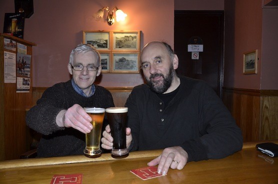 Brian Mc Daid celebrates with follow walker Paddy Walsh in O Donnell's , Burtonport after Brian completed a walk tracing the route of the Old Lough Swilly Railway Line from Derry to Burtonport. Photo By Mary Rodgers