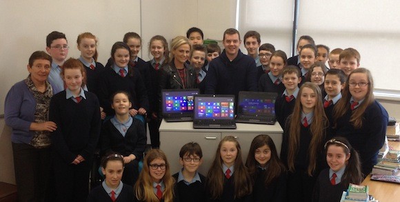 Danny and Amanda O'Carroll with principal Anne Foxe and pupils.
