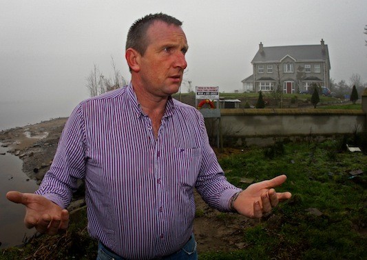 Joe Lynch outside his home at Carrickmore, St Johnston which will not be demolished after a ten year legal battle. 