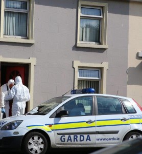 Forensic experts carry out their investigations at the house were the young man died. 