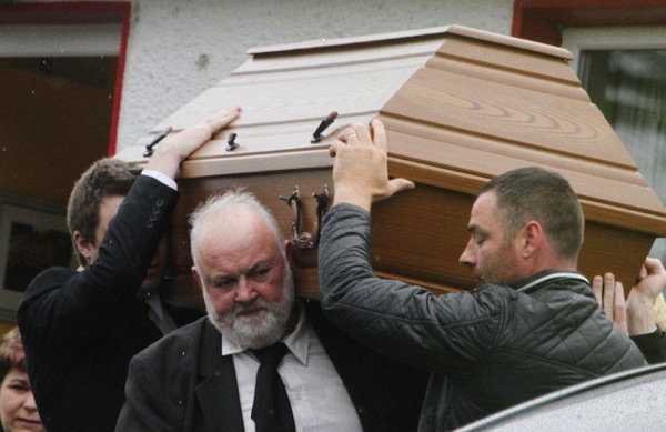 Patrick McLaughlin (left) helps bring his son Enda to his final resting place.