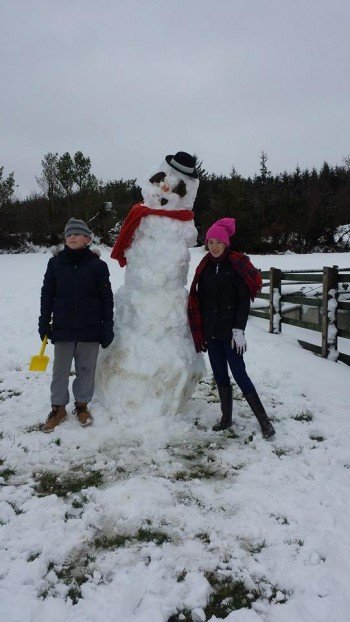 These kids from Milford enjoyed their day off school by sculpting this huge snowman. Picture by Marie McGrory. 