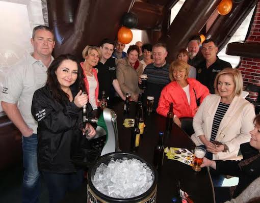 Family and friends help Catriona pull the first pint at the Pop-Up-Pub!