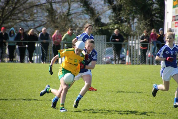 Amy Boye Carr (N Conaill) has her shirt pulled as she runs at the Cavan defence.