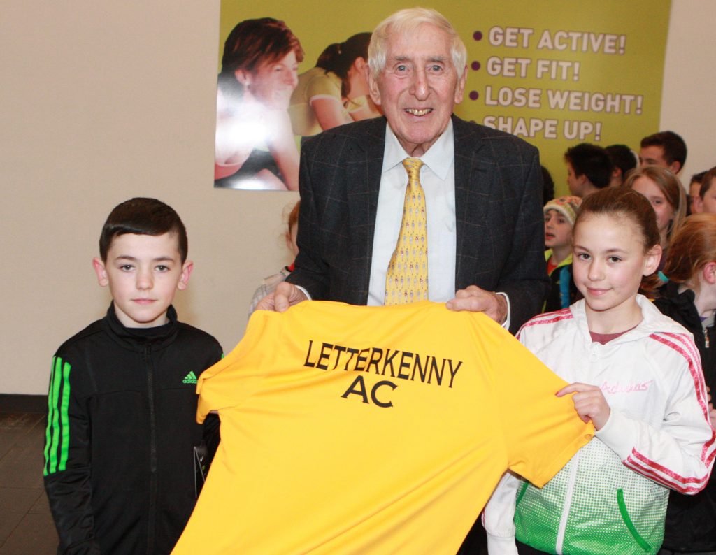 Jack and Emma Prics making a presentation to Olympic Gold Medalist in the 1956 games Ronnie Delaney