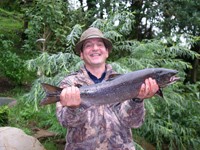 Athos shows off a salmon caught on the Blackwater River