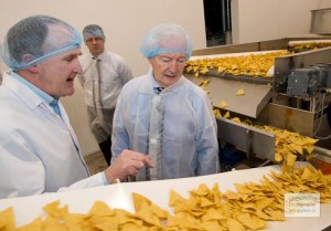 Dinny, pictured agreeing a huge grant for a Gaoth Dobhair crisp factory. It has now closed