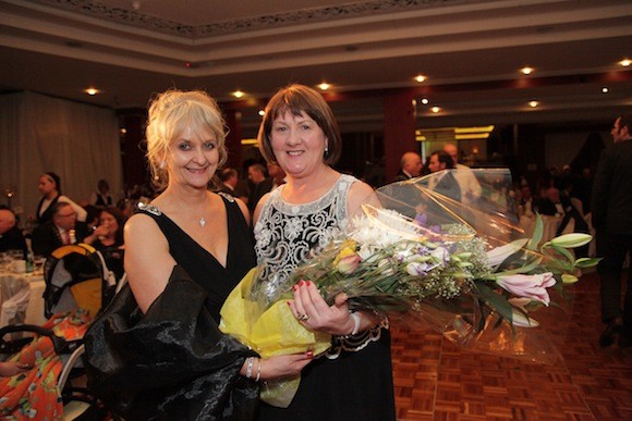 Marian Caffrey presenting flowers to Mary Harte