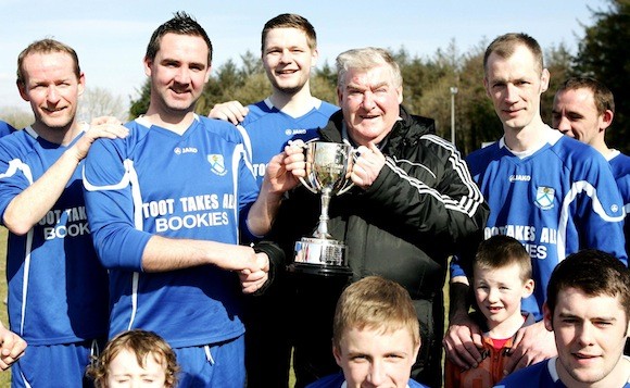 Donegal Junior League Administrator Terry Leyden pictured presenting the Glencar Inn Saturday Division Two League Trophy to Gary Crawford captain of Deele Harps who secured the title on Saturday with victory over Keadue Rovers Reserves