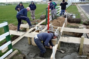 Club and Community unite to get the cement bases in.