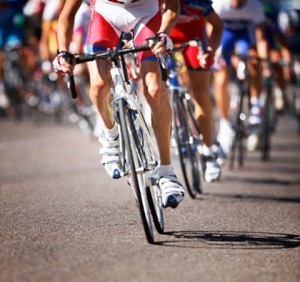 Road cyclists racing at Tour de France (low section, low angle view)
