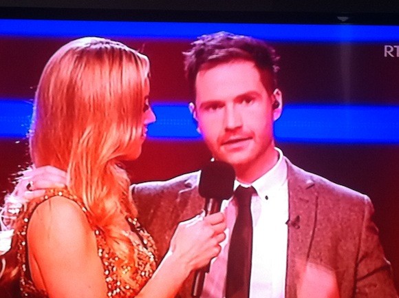 Shane is congratulated by presenter Kathryn Thomas