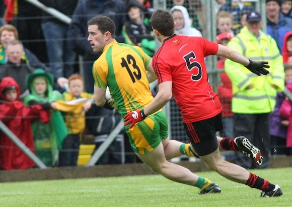 Donegal's Patrick Mc Brearty in possession as Down's Declan Rooney closes in