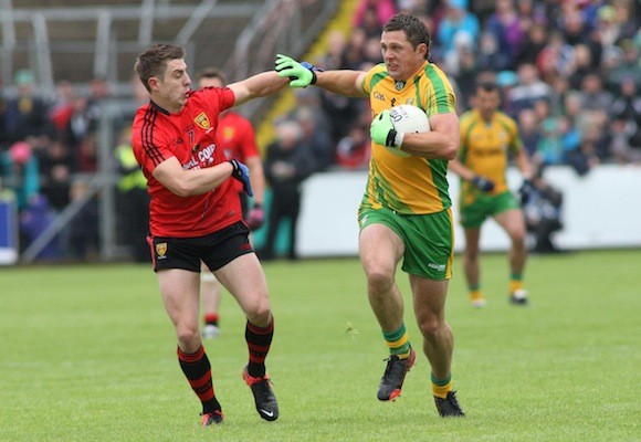 Donegal's Ryan Bradley holds off the challenge of Down's Ryan Boyle during the Ulster Senior Football Championship semi-final at Breffni Park