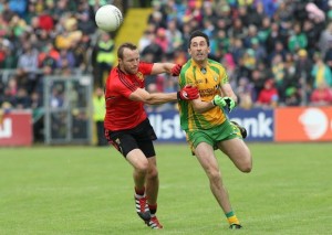 Rory Kavanagh gets his pass forward despite Ambrose Rodgers' tackle