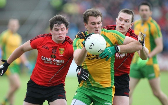 Under pressure but Donegal's Eamonn Mc Gee holds possesssion against Down