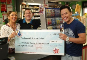 Donna, Sacha, and Ryan with the UK Lotto cheque for €88,000 in the shop where he bought the winning ticket
