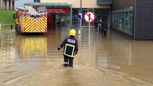 A fireman wades through the water outside the hospital last Friday.