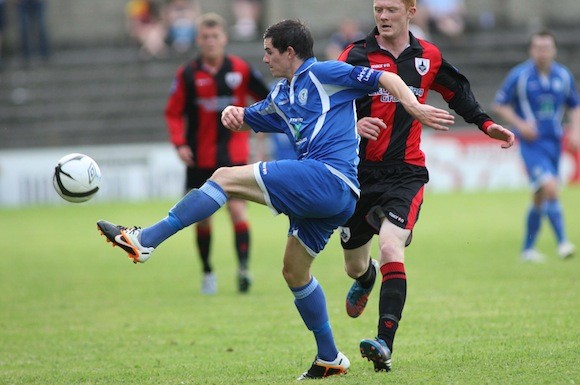 Ciaran Coll clears the ball as a Longford Town player closes in. Pic.: Gary Foy