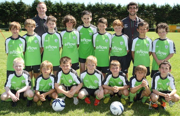 Pictured at the Donegal Junior League's FAI Summer Soccer School at Diamond Park, Ballyare are Head Coach Stephen Corcoran and School Coach Kieran Mc Daid with one of the participation groups.
