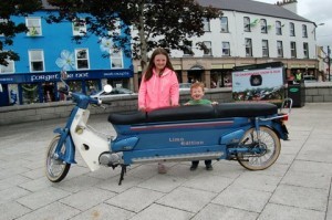 Cousins Erin & Kian Gallagher pose behind a special "Limo" Honda 90.