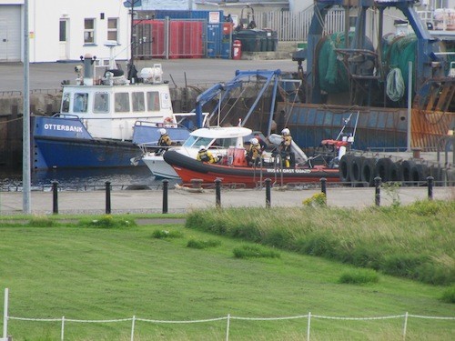 The latest stricken vessel being towed into Greencastle Harbour by the local Coast Guard lifeboat.