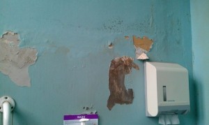 Paper and paint was peeling off the walls.