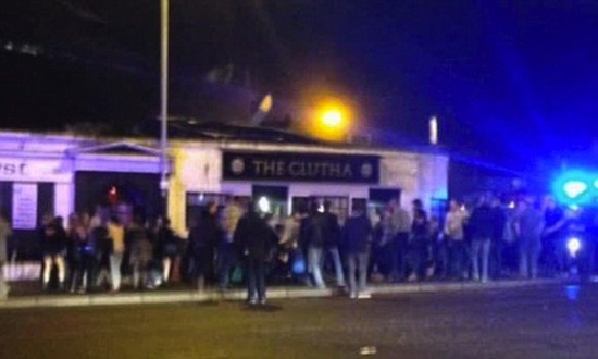 People rush to the scene of the helicopter crash at the Glasgow pub.