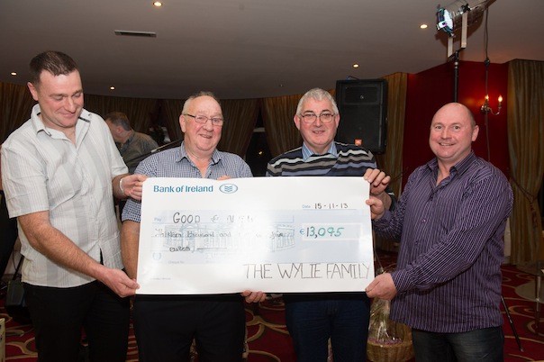 Alan Wylie, Jnr, Alan Wylie, Snr. and Trevor Wylie (right) present  Eamon McDevitt, Good and New Chairity shop with €13,905 euros raised on the Wylie Family Tractor Run held in September and dance at the Clanree Hotel on Friday night.  Pic Clive Wasson