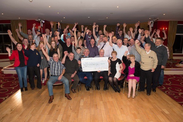 Drivers and supporters with Eamon McDevitt, Good and New Chairity shop who received a cheque for €13,905  raised on the Wylie Family Tractor Run held in September and dance at the held in the Clanree Hotel on Friday night.  Pic Clive Wasson