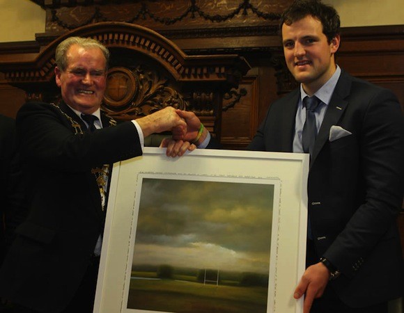 Michael receives a gift of a picture of a GAA field from Mayor McGarvey.