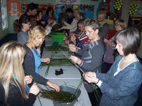 European teachers learning the art of making St. Brigid crosses at St. Baithin's N.S., St. Johnston.  