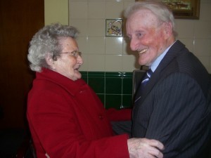 Family friend Maggie Keeney, 96, congratulates John on his wedding anniversary.