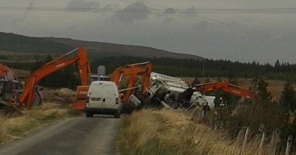 Diggers work to clear the road after a truck containing wind farm parts went off the road in Dunkineely.