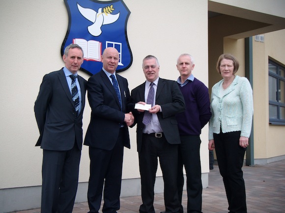  Both photos show Brendan McGlynn presenting a sponsorship cheque to Cllr. Jimmy Kavanagh, Chair of Errigal College Board of Management.  Also present is Acting Principal, Charlie Cannon and Eileen Maguire and Ciaran Rodgers for the school Extracurricular Committee 