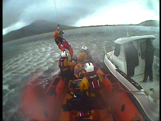 The fisherman is lifted onto the Lough Swilly RNLI lifeboat to be brought ashore and to flown to hospital. Pic courtesy of Lough Swilly RNLI.