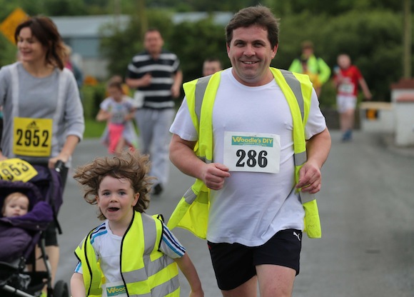 Former Sean Mac Cumhaills' player Martin Mc Laughlin shows the next generation how it is done during the Sessiaghoneill NS 5K Fun Run & Walk. Pic.: Gary Foy, newsandsportfiles