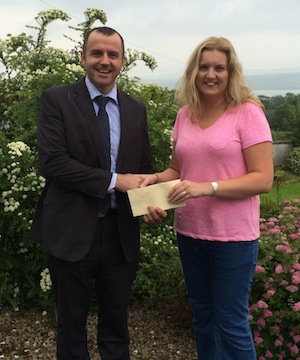 Brian Sweeney PRO Loughside Community presents a cheque to Janet Russell Cashelshanaghan NS