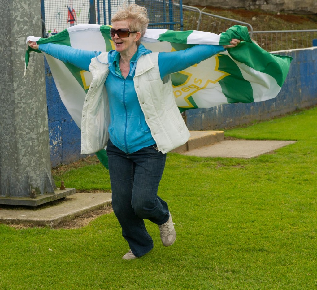 A delighted St Catherines fan leads the pitch invasion after the final whistle.  Photo Clive Wasson