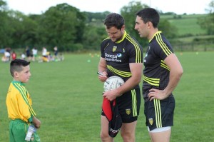 Michael Murphy and Rory Kavanagh sign a ball for a stunned young fan!
