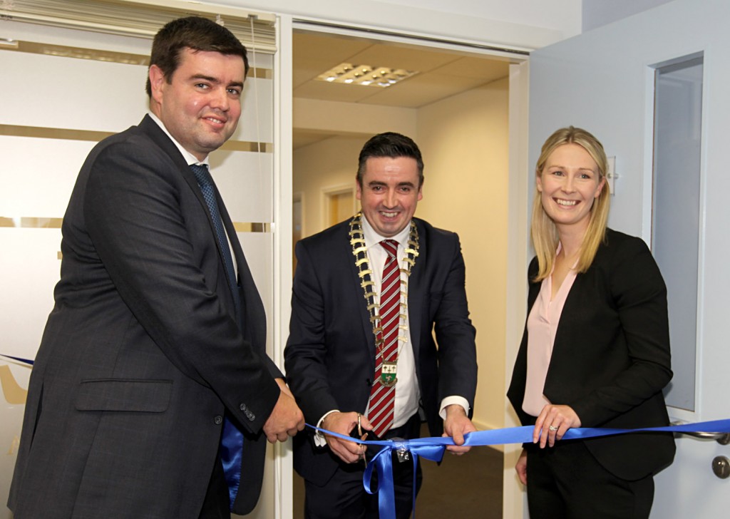 Gerard Grant Chairman of Letterkenny Chamber cuts the tape to oficially open Nathaniel Lacy Partners Solicitors new offices at the Riverside Centre, Letterkenny with l-r t Nathaniel Lacy and Jill Grant (solicitor).