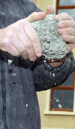 Damien Mc Cauley demonstrates how weak the blocks are from his house built in 2006 . all the out wall have to be replace at his family home, and his family had yo be moved out. Photo Brian McDaid